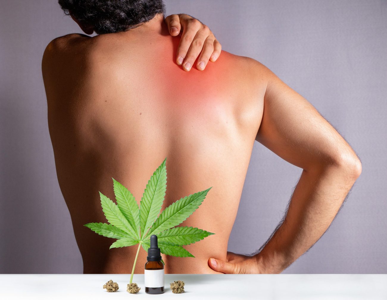 CBD oils designed for athletes to treat muscle discomfort, oil made from cannabis extract to care his injured back, medical pain treatment. Isolated on gray background